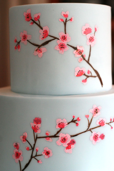 Premium Photo | White wedding cake with cherry blossoms brick wall and dark  background